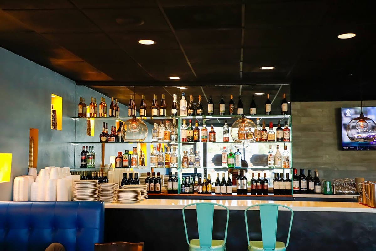 Bombay Cafe bar shelves stocked with wines and spirits