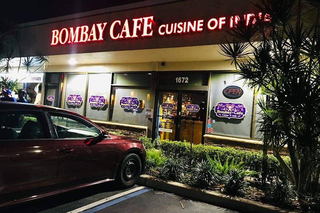Bombay Cafe exterior at night — Cuisine of India neon sign