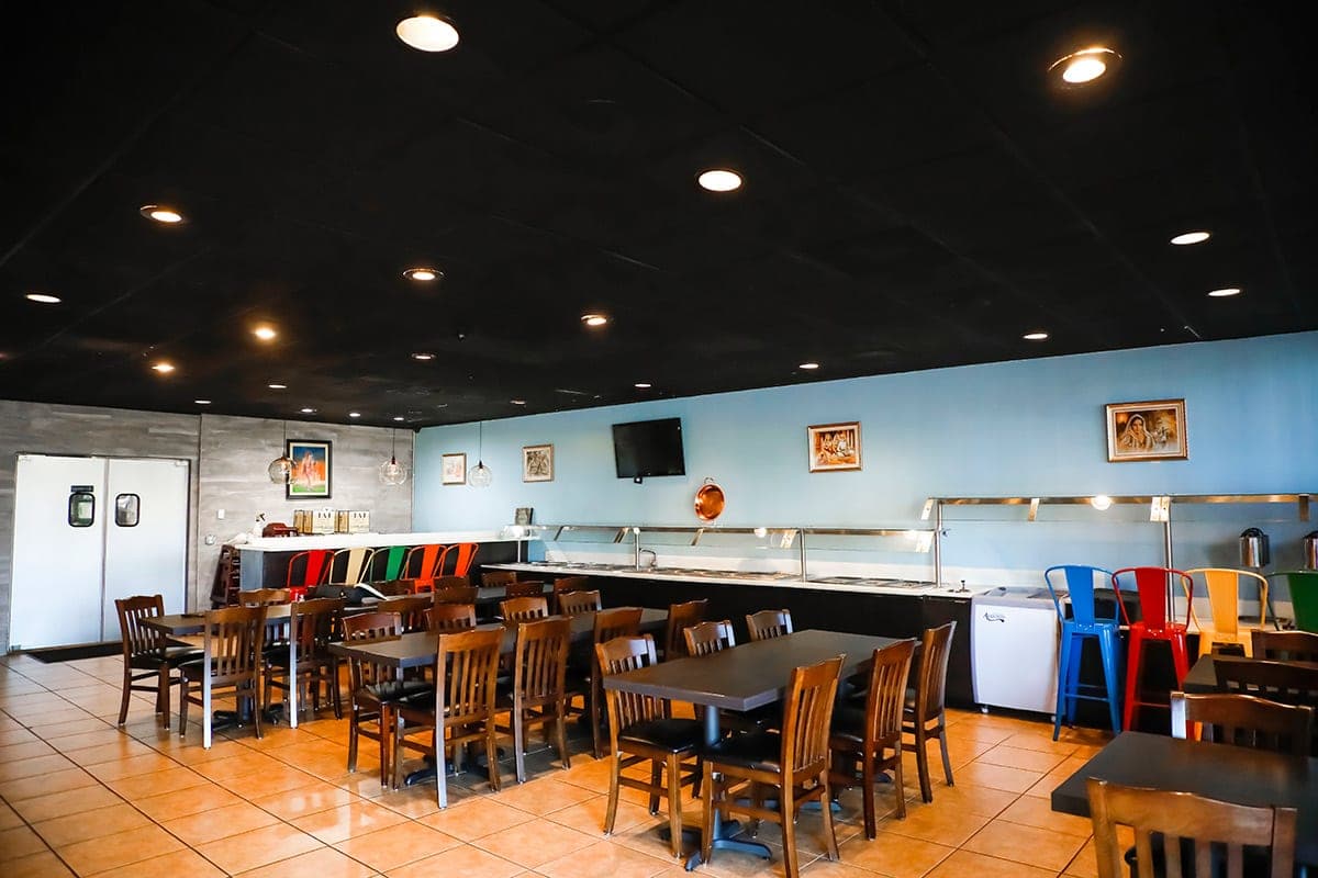 Dining hall with colorful chairs and warm wood seating